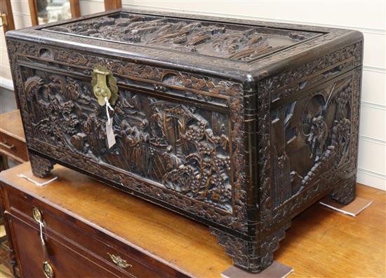 A Chinese carved camphorwood trunk W.90cm